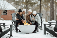 Family gathered around a fire pit in the snow