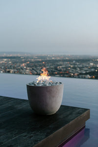 Fire pit with a cityscape view at dusk