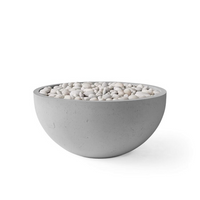 Concrete bowl filled with small stones on a white background