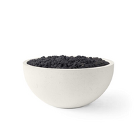 White bowl filled with black sand on a white background